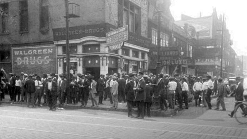 African American men in front of Walgreen Drugs (now called Walgreens) at 35th and S. State St. in the Douglas community area, tags: wall - CC BY-SA